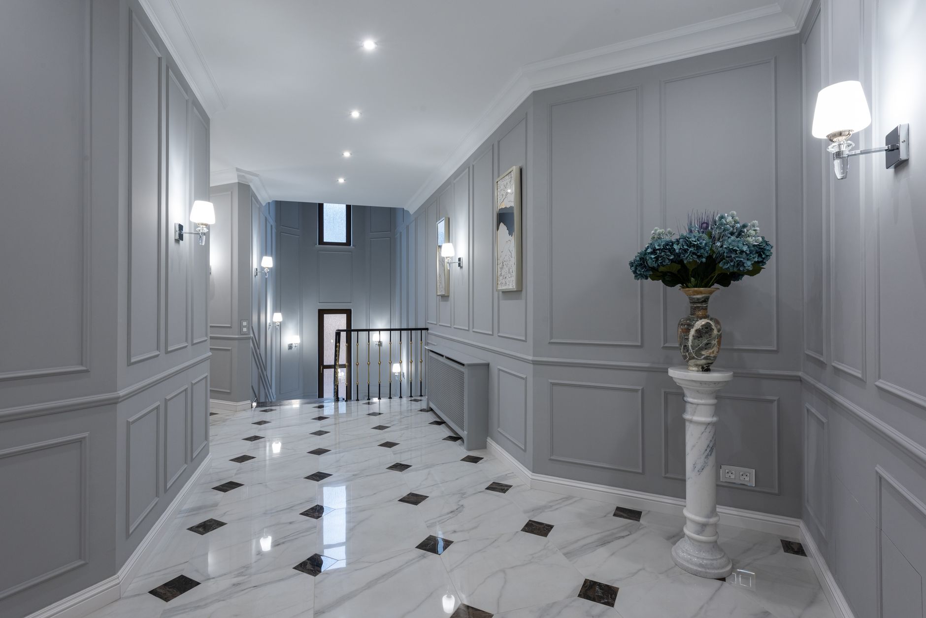 Polished marble flooring in a Missouri hallway with panelled grey walls