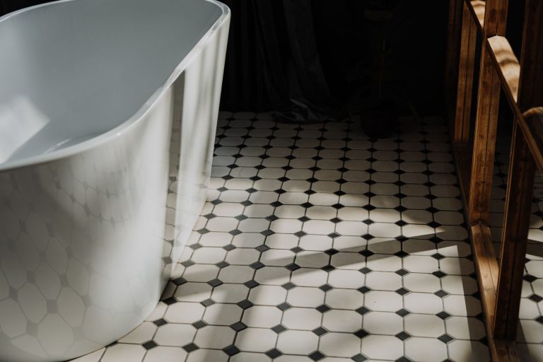 Black and white hexagonal tile flooring in a Missouri bathroom with a freestanding tub