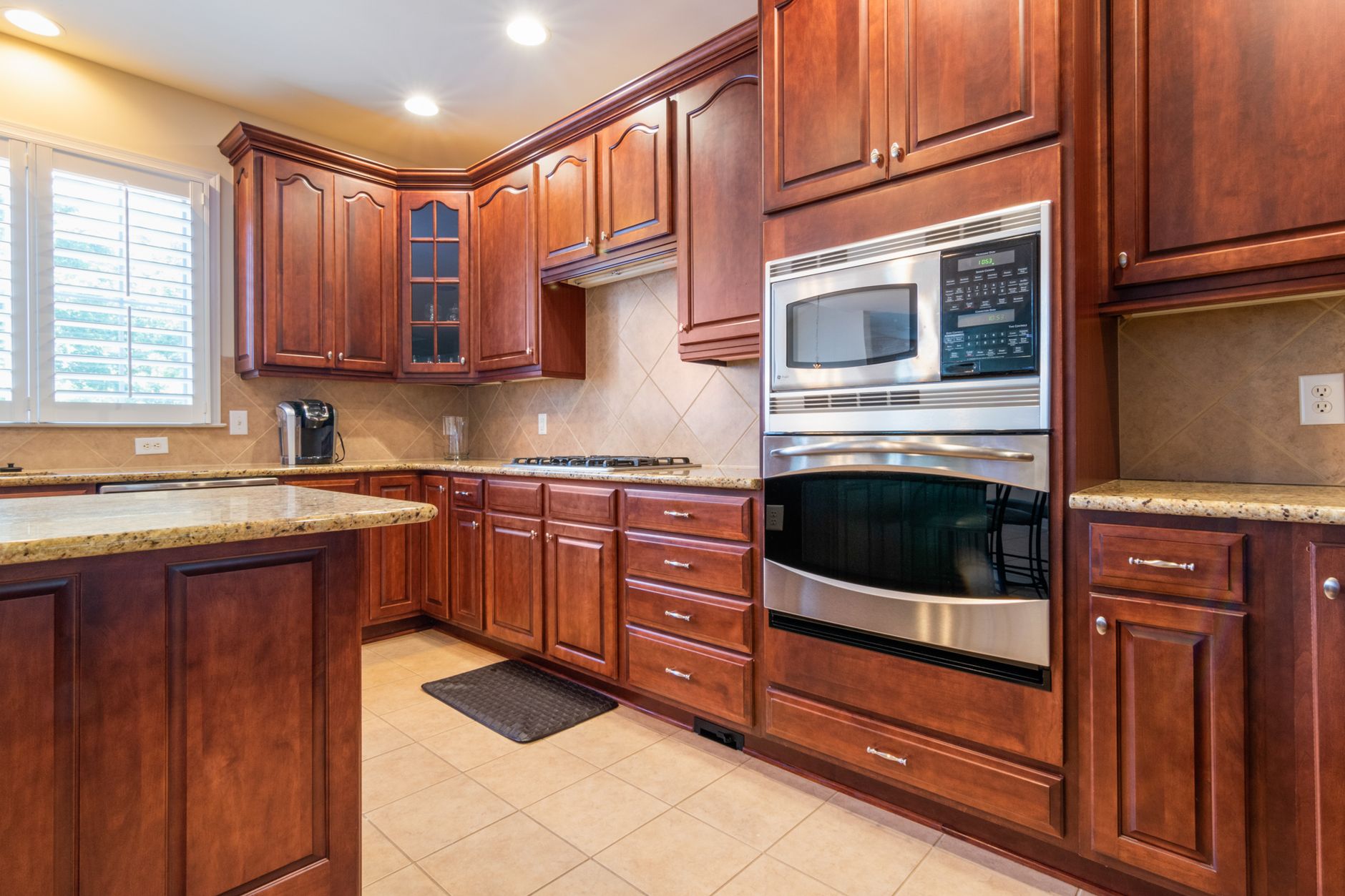 Spacious kitchen with wooden cabinetry and built-in appliances. Elegant and functional interior design